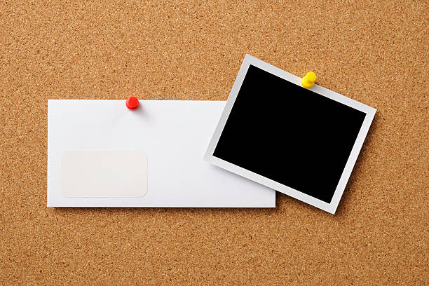 istock Blank Polaroid with envelope pinned on cork board 158946938