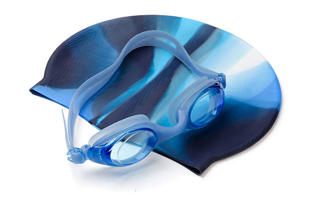 Swimming cap and goggles Blue swimming cap and goggles isolated on white swimming cap stock pictures, royalty-free photos & images