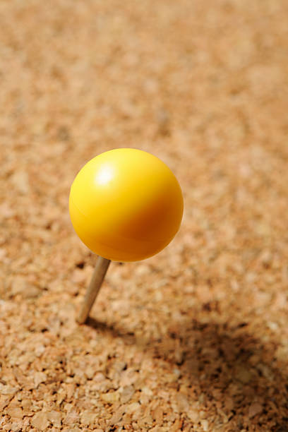 istock Close-up of Cork board with yellow thumbtack 158946996