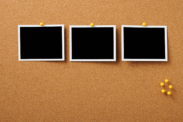 Three blank Polaroid pinned on cork board with yellow thumbtack Three blank Polaroid pinned on cork board with copy space. bulletin board photos stock pictures, royalty-free photos & images