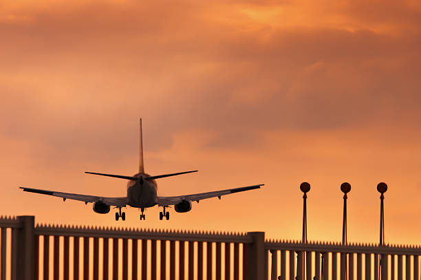 Arriving jet at sunset stock photo