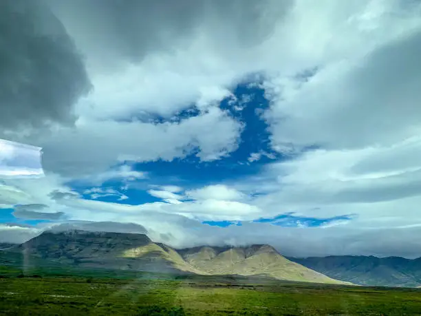 scenic natural untouched rural green landscape of Icelandwith scenic cloud formation, Island