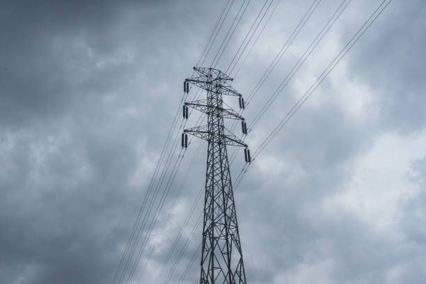 istock Power lines high voltage on dark cloudy sky electric wire 1589491029