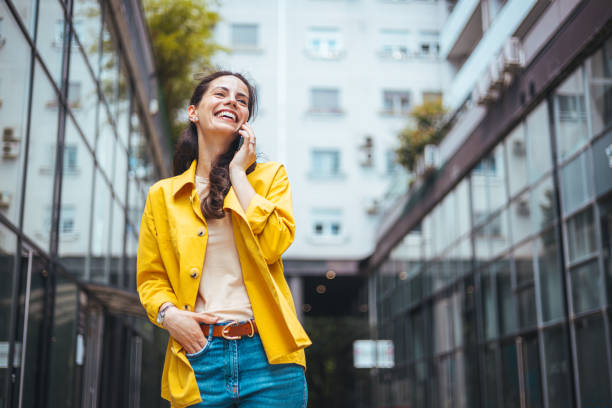 istock Happy woman talking on smart phone. 1589492089