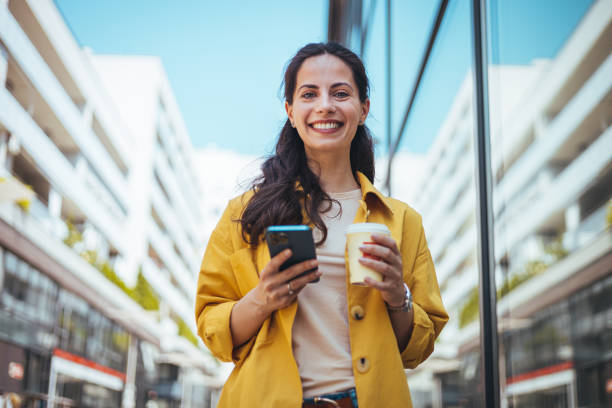 istock Woman surfing the net while drinking coffee outdoors. 1589493193
