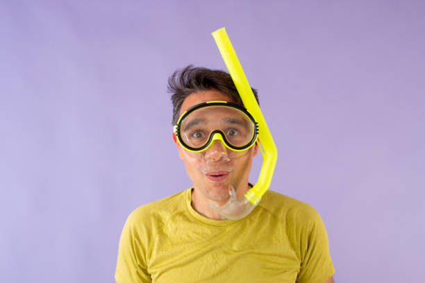 hombre con gafas y snorkel vestido con ropa de colores brillantes - shirtless front view studio shot waist up fotografías e imágenes de stock