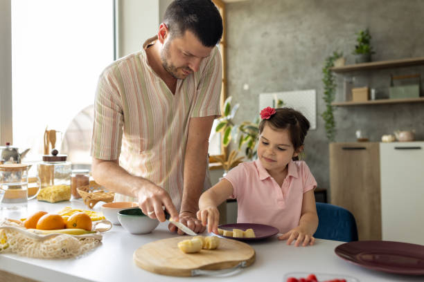 istock Father and daughter making a fruit salad at home 1589498996