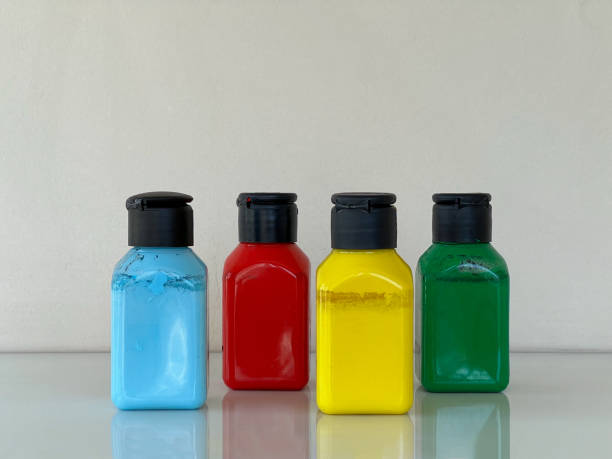 istock Bottles with bright multi-colored acrylic paint on a simple background 1589504413
