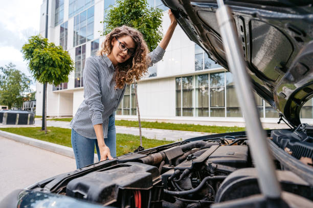 istock Young Woman Having Car Problems On The Street 1589504995