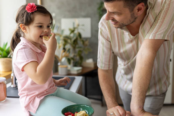 istock Father and daughter making a fruit salad at home 1589508833