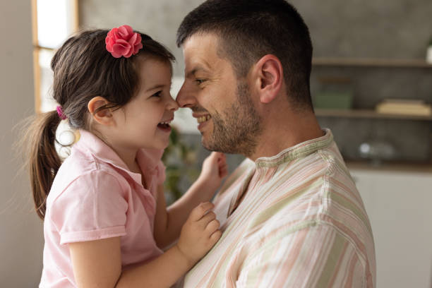 istock Father and daughter embracing at home 1589512322