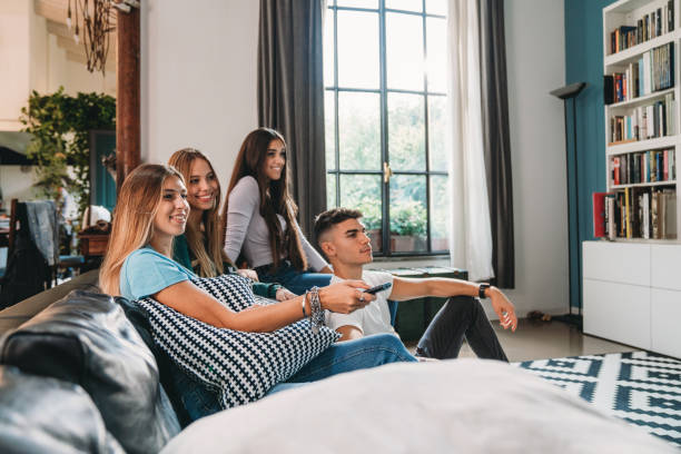 istock Four friends watching tv at home 1589526227