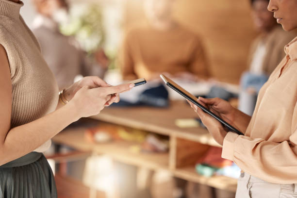 istock Business, closeup and women with technology, hands or share ideas for new project, creativity or website launch. Female employees, consultants or coworkers with device, smartphone or tablet in office 1589528685
