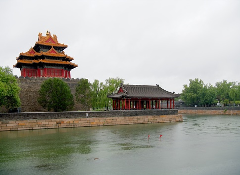 Rainy morning at Corner Tower or the Turret of The Forbidden City is famous for its unique shape and its beautiful style. The Corner Towers are located in the four corners of the Forbidden City. It was first built in 1420 (Yongle 18, Ming Dynasty) and was rebuilt and renovated in Qing Dynasty.