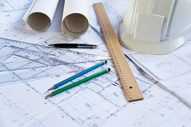 Blueprints, pencils, rulers and a hardhat