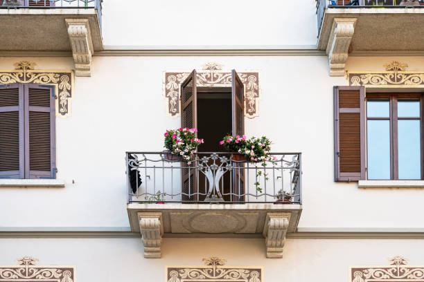 Balcony with plants and closed French window shutters on house in Bonifacio, Island of Corsica, France. Copy space to the left.