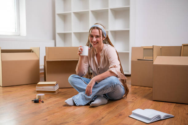 istock Happy ginger woman drinking coffee in her new home 1589542196