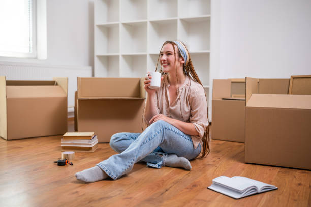istock Happy ginger woman drinking coffee in her new home 1589542201