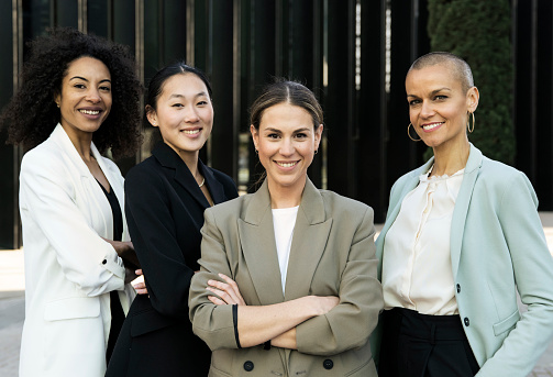 Multiracial group of successful confident women office corporate professional experts. Female team smiling looking at camera. Business concept. High quality photo