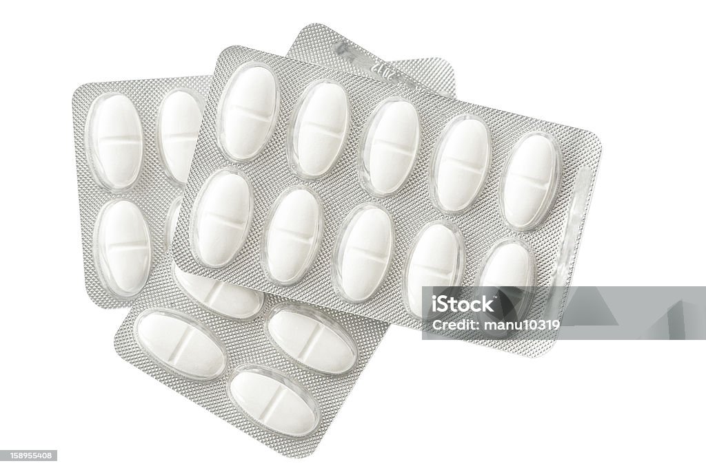 Medication and tablets background Medication and tablets background with a shot of a blister pack containing white pills for the treatment of an illness, or as a dietary supplement or vitamin to ensure good health Abstract Stock Photo