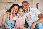 Family in portrait, parents and happy child relaxing at home in support, love or bonding together on sofa. Happiness, people or living room with relationship and spending quality time at the weekend