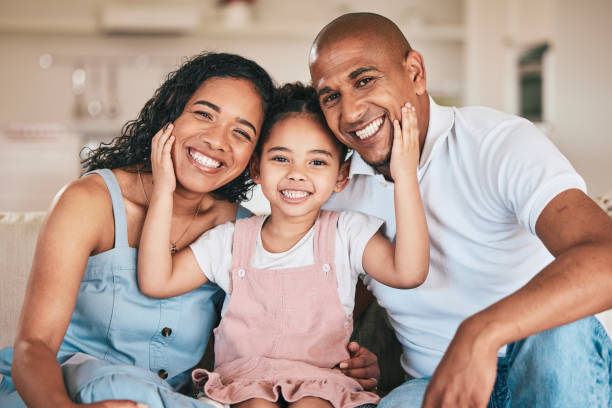 Family in portrait, parents and happy child relaxing at home in support, love or bonding together on sofa. Happiness, people or living room with relationship and spending quality time at the weekend stock photo