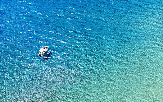 Boat floating at turquoise waters of Bozcaada - Tenedos. Horizontal composition with copy space. Travel and vacation concept.