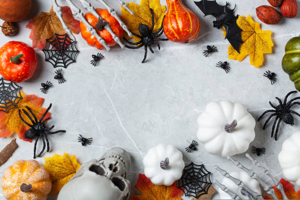 istock Halloween greeting card with pumpkin, skulls, bony hands and spiders 1589561700