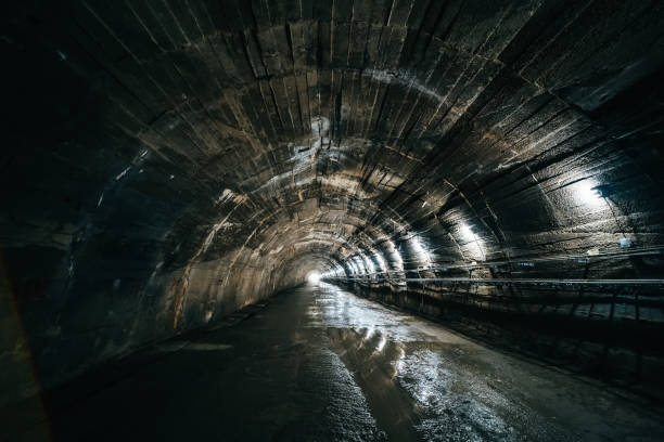 istock Long concrete underground industrial tunnel or corridor 1589562227
