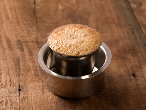 Indian filter coffee on wooden background