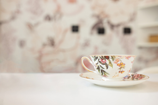 An old-fashioned floral patter tea cup on a table