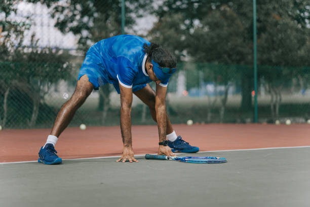 istock Asian professional tennis player warming up before tennis game 1589615320