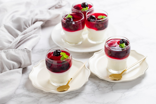 Italian dessert panna cotta in glass with cherries