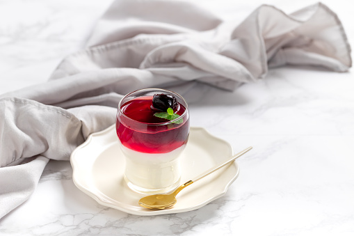 Italian dessert panna cotta in glass with cherries