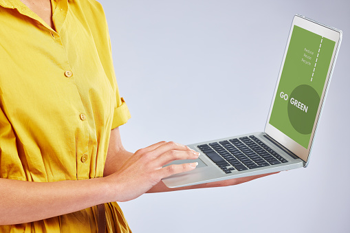 Woman hands, laptop screen and eco friendly website, sustainability research and green technology on white background. Typing, planning and climate change of person on computer and website in studio