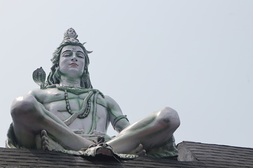Hindu Adiyogi Shiva statue. Huge statue of Lord Shiva at the entrance of Triveni Ghat, Rishikesh. Shiva in the posture of yoga while meditating