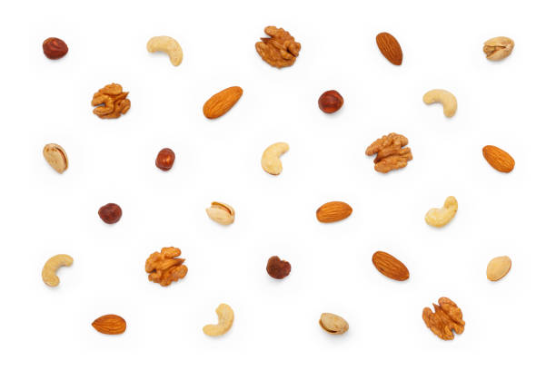 istock Background from different types of nuts and seeds. Isolated on white background 1589695665