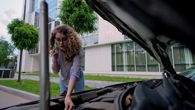 Young Woman Calling Road Assistance Because Of The Car Problems On The Street