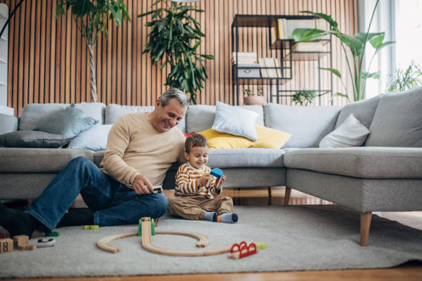 istock Boy and grandfather playing together 1589711738
