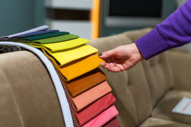 istock The woman chooses the fabric on the sofa. 1589716076