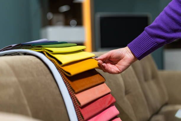 istock The woman chooses the fabric on the sofa. 1589716081