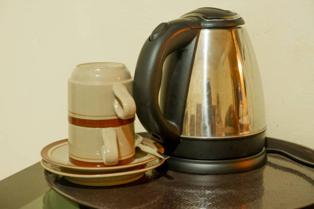 istock An electric teapot and a stack of cups on the table. 1589724717
