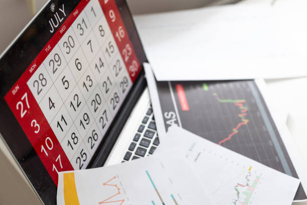 istock Preparing report. Blue graphs and charts. Business reports and pile of documents on gray reflection background. 1589728009