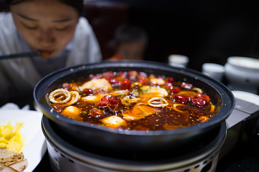 Eating hotpot is a very popular Chinese cuisine, usually consumed during winter or cold weather. The main feature of hotpot is to cook various ingredients in a shared pot and then dip them in sauce before eating.
