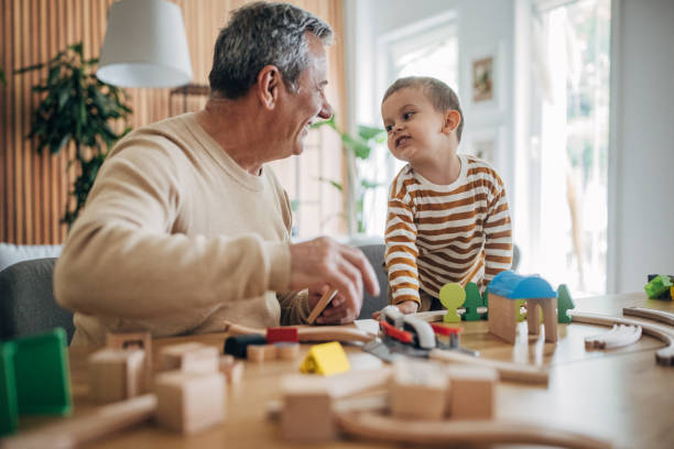 istock Grandfather and grandson playing 1589734453