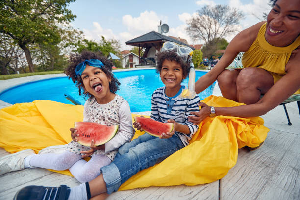Summer Delights: Afro-American Family's Refreshing Poolside Watermelon Feast