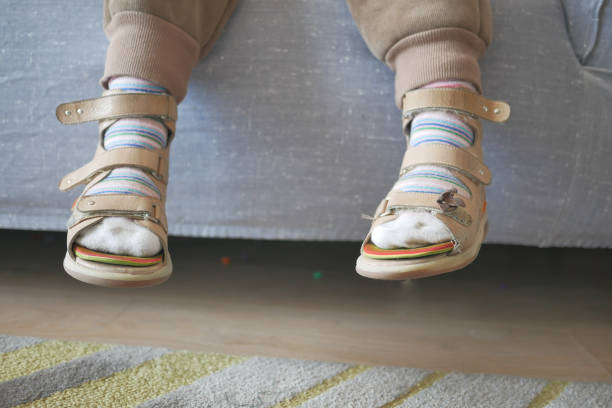 istock Child cerebral palsy disability, legs orthosis. 1589740545