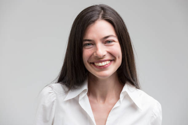 istock Smiling woman in formal white shirt 1589741394