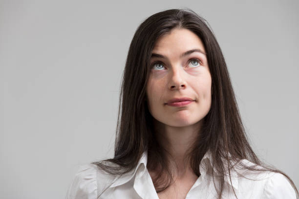 istock Imaginative woman gazes up, strategizing 1589743476