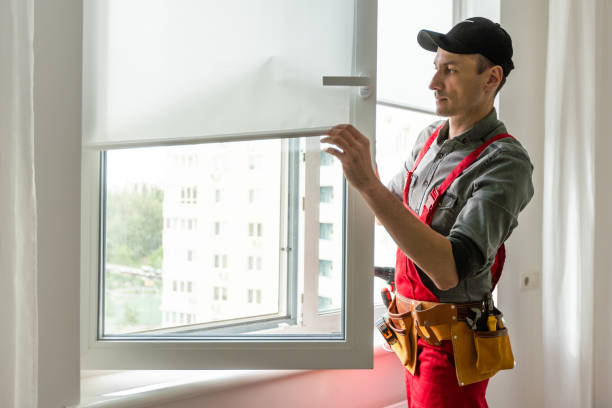 istock Man putting rubber draught strip onto window indoors 1589753513